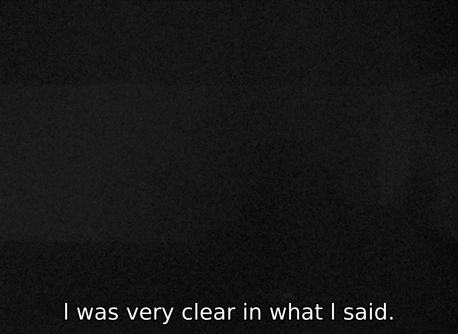 A very dark
      screen, in which the outline of a small room with a hunched figure can
      only barely be discerned. The subtitle reads, 'I was very clear in
      what I said.'